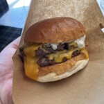 THE CHEESE BURGER - バーガー袋に入れ、手に持つとズッシリとしたサイズ感。