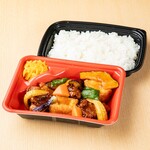 Chicken sweet and sour sauce bento with colorful vegetables and fried tofu