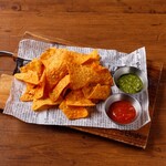 Tortilla chips with basil and tomato sauce