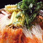 韓サラン -  自慢のカムジャタン  骨付き豚肉のだしをすったほくほくのじゃがいもがたっぷり！  香ばしいエゴマの葉の風味も食欲をそそります！ 