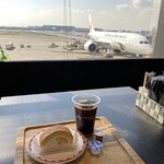 TRAVELER'S COFFEE - Iced coffee and fruit roll cake with an airplane in the background