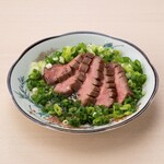 Beef tongue covered in green onions