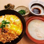 Small pot with water and oyakodon Oyako-don (Chicken and egg bowl)