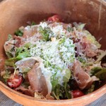 Caesar salad with freshly shaved Parmigiano cheese and Prosciutto