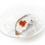 Oyster cocktail with lemon sauce and salmon roe