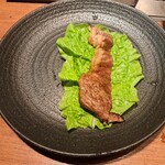 焼肉うしごろ - サンチュの上に、網の鉄板で焼いた北海道産黒毛和牛A5サーロインをのせた様子その1です。