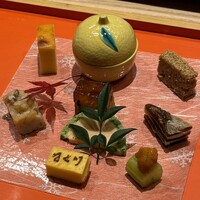 寿司 はせ川 心斎橋本店 - ゆり根カステラ、サーモンテリーヌ、菜の花松前漬け、松の実松笠焼き、セロリ糀漬け雲丹、厚焼き玉子、柿チーズ、河豚煮凝り、鶏松風