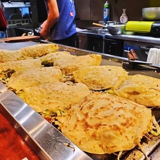 Enjoy the impressive Okonomiyaki that is cooked right in front of you!