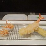 旬彩 天ぷら 心来(しんら） - 活け車海老：つい先ほど、大将が わたし達の前で生きた車海老を取り出して、殻を剥いたばかりの新鮮な車海老をややレアな食感で楽しめる様に揚げますていきます。 美味しいに決まってますよねェ～！（嬉） くも：活け車海老の頭部がサクサクでカリッと揚げられています。 “心来” さんの天ぷらコースの定番ですネ！  粟麩：モチモチで、熱々ッ！ 塩でも天つゆでもどちらもOKだそうです。