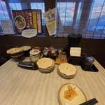 博多ラーメン 琥家 - 卓上にからし高菜、辛いもやしなど無料トッピングあり