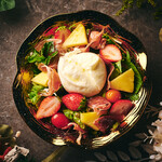 Colorful salad with burrata cheese and fruit