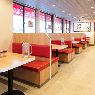 The clean interior of the restaurant allows you to sit around a table and enjoy your meal with friends.