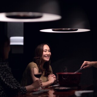 A fully attended Yakiniku (Grilled meat) restaurant where the staff grills the meat right in front of you.