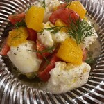 Fruit tomato and burrata caprese with orange flavor