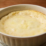 White ragu soufflé gratin with egg and homemade salsiccia