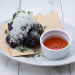 Squid ink zeppole with parmesan cheese