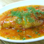 Boiled white fish with herbs and tomato