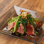 Grilled bonito and seasonal vegetable salad with spicy gochujang and fresh shichimi sauce