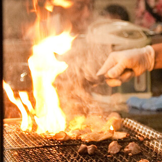 The audience seats surround the ``Yakiba'', the symbol of Yakitori (grilled chicken skewers)!
