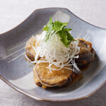 Fried minced eggplant with scissors