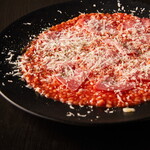 Tomato risotto with salami and cheese