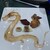 翠林 - 料理写真:たまり醤油で描かれた龍　鶏レバーの焼物　手羽先の詰め物　豚耳