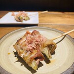 Pork-wrapped skewers of myoga and eggplant served with plum miso