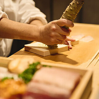 Late at night, the restaurant serves up Sushi dishes and alcoholic beverages in a bar setting.