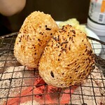 Horumon Riki - 七輪で焼くおにぎり(2個)@250円  まずは白いおにぎりを満遍なくこんがりと焼きます。全身がしっかりと焼けたら醤油ダレを刷毛で塗り塗り。香ばしい香りが漂ってきたら食べごろ。いやぁ、たまらんちん！