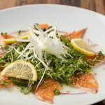Japanese-style salmon carpaccio covered in green onions