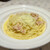 ピッツェリア - 料理写真:パスタAセット（税込み１４０８円）の半熟卵のカルボナーラ