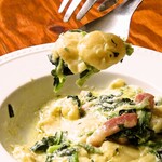 Homemade gnocchi with spinach and salmon cream sauce