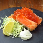Rare salmon fry with spilled salmon roe