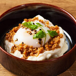 Potato salad with poached egg and meat sauce