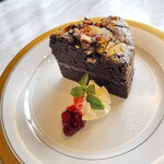 Gateau chocolate with nuts and raspberry
