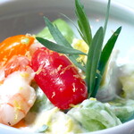 Colorful tomatoes, shrimp, and avocado tossed in celery and yogurt