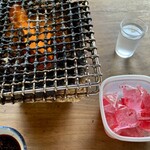 野沢屋 - 着火剤を自分で汚い網を持ち上げて投入、チャッカマンで火を着けます