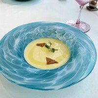 リストランテ　ウミリア - とうもろこし(ゴールドラッシュ)の冷製ポタージュ
                    
                    えんどう豆の新芽とカリカリに焼いたチーズがアクセント。とうもろこしの甘さが前面に出ていて、夏らしいさっぱりとしたポタージュ。