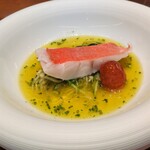 馳走西健一 - 神経〆の金目鯛：船上で神経〆した 綺麗な赤色が印象的な金目鯛が 魚介のお出汁・サフラン・ハーブのスープに 細切りにしたズッキーニとローストしたプチトマトと共に提供されます。ほんのりと柚子が香ります。♪♬