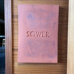 SOWER - レストラン入り口。陶板？の看板です。