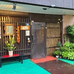 鮨匠 のむら - 外観はマンション1階にあり、黒塗りの木の格子、ガラス窓とある黒塗りの引戸扉、ファザードには沢山の鉢植えがあり、緑が豊かで落ち着いた佇まい