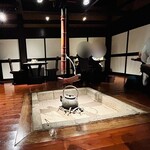白金亭 - 1Fメイン広間の中央には大きな囲炉裏が…
      それを囲むようにテーブルが設置されている