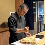 瞬 - 渡り蟹のピザにスダチを搾る大将