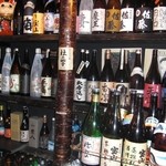 三拍子 - 玄関入ると、右側に焼酎の棚があり、お目当ての焼酎を探してください