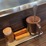 びっくり亭 - 卓上の辛味噌と傾ける木の棒です。