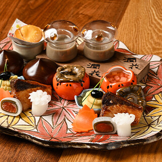 "Sashimi and grilled dishes are served on a large platter."