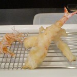 旬彩 天ぷら 心来(しんら） - ◎活車海老：つい先ほど、大将が わたし達の前で生きた車海老の殻を剥いたばかりの新鮮な車海老を揚げていきます。サクッとして衣に包まれた活車海老は 美味しいに決まってますよねェ～！ ◎くも：活車海老の頭部がサクサクでカリッと揚げられています。◎マコモダケ：筍とトウモロコシを併せた様な美味しさです。