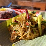 カフェモン - ゲェーン・ホッ。
      中華春雨を豚肉、インゲン、小松菜、唐辛子、そしてタケノコを発酵させた漬け物『ノーマイドーン』と一緒に彩り鮮やかに炒めています♪
      ハンレー粉で黄色く染まった春雨がうまそう！