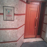 銀座 テンダー - 高級感のあるフロアデザインで、木製ドアが落ち着いた印象の上品な店構え