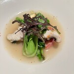 アンティキ - スズキのポワレ　菜の花と貝の旨味のスープ仕立て